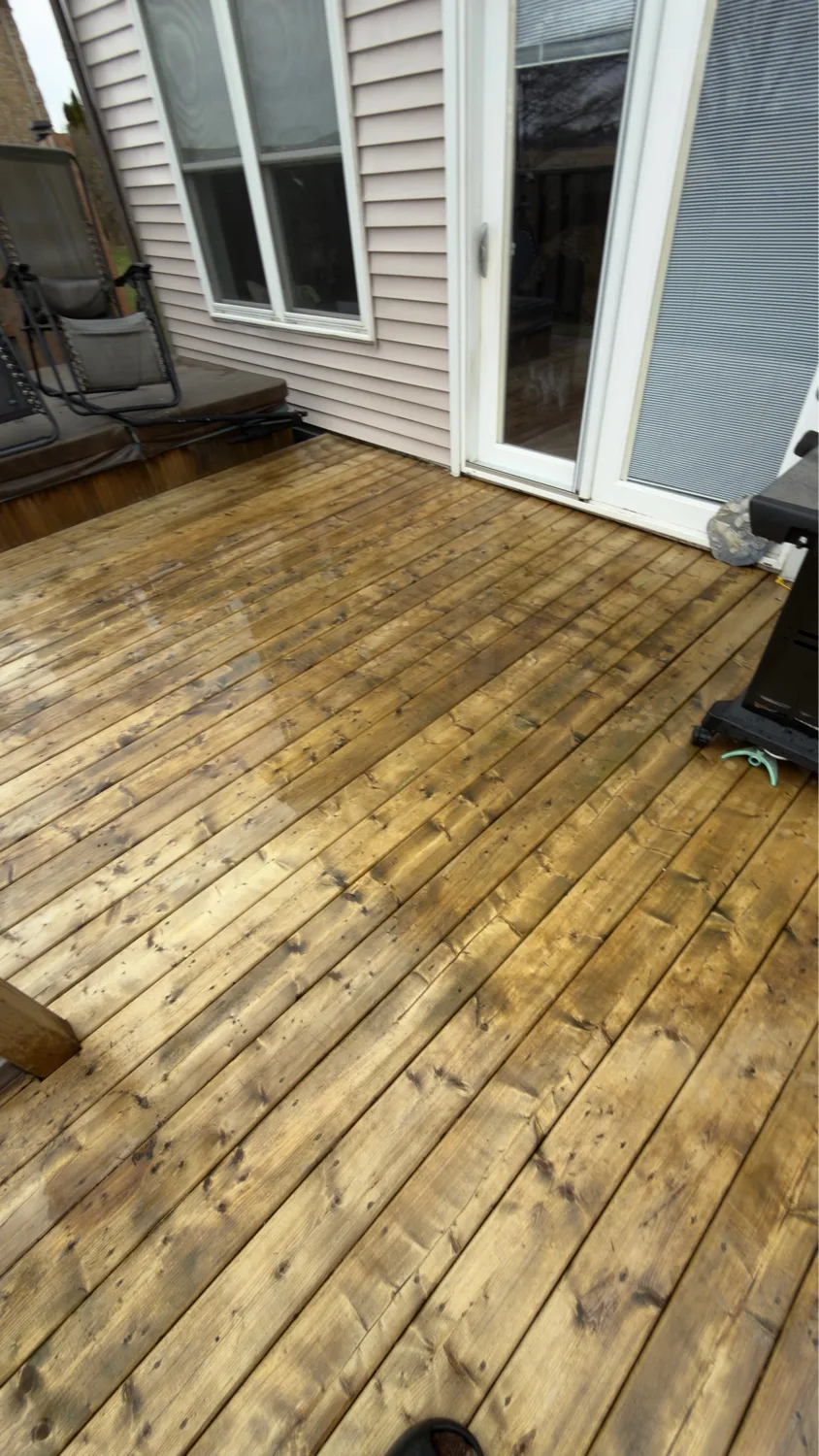 Pressure-treated deck with fresh stain finish at sliding patio door — D&D Exterior Finishing Kitchener-Waterloo