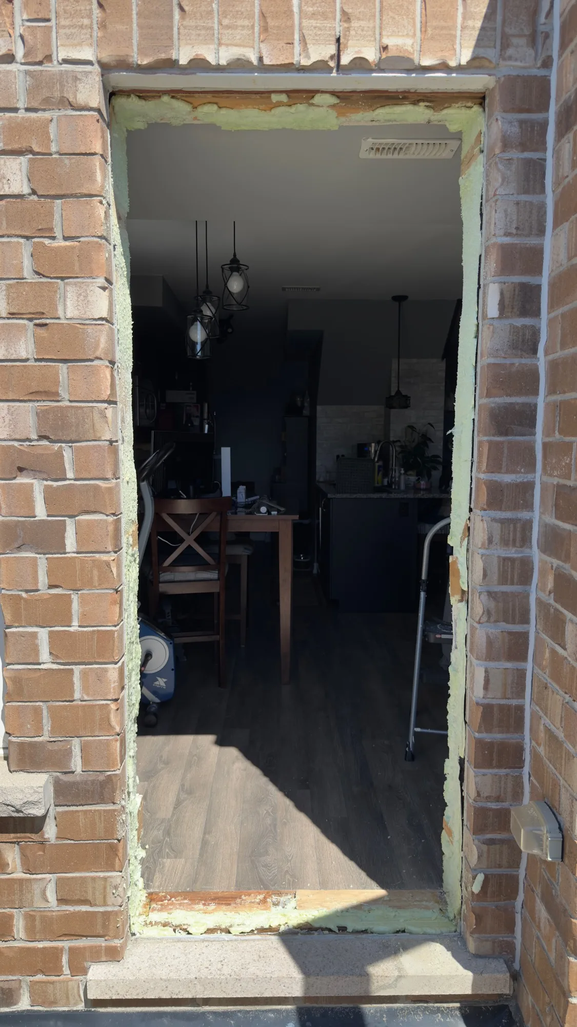 Exterior brick door opening prepared for new door installation — old frame removed, ready for fitting