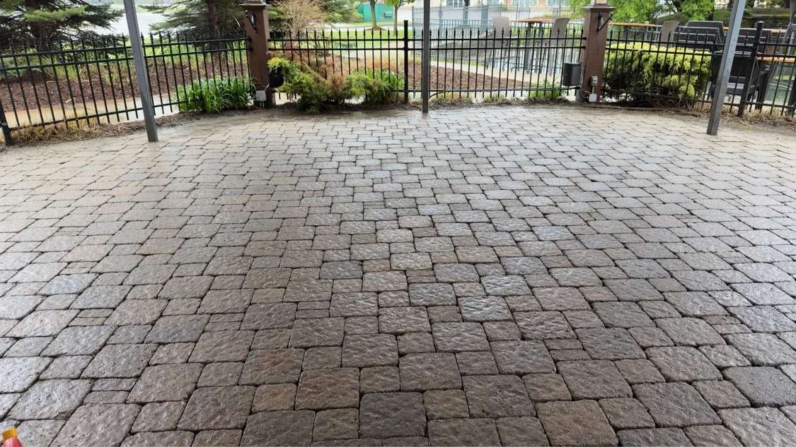 Completed interlock paver patio with iron fence — Kitchener-Waterloo installation