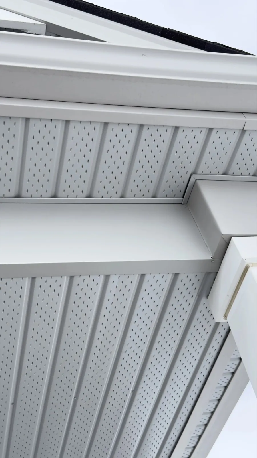 White soffit panels and fascia around a covered entrance