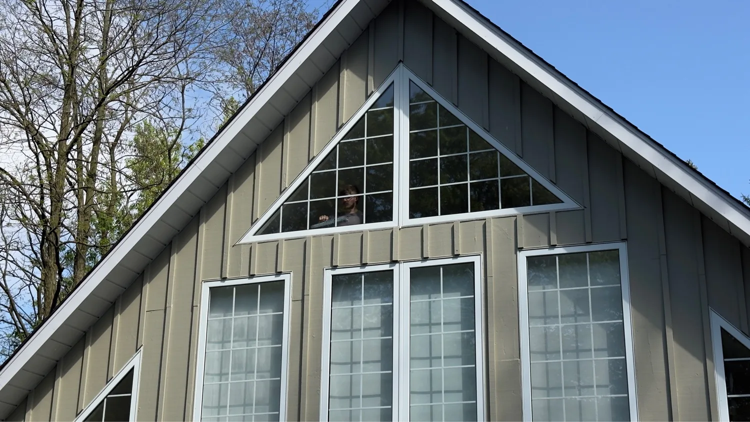 Custom triangular gable window with grid-pattern glazing — D&D Exterior Finishing Kitchener-Waterloo
